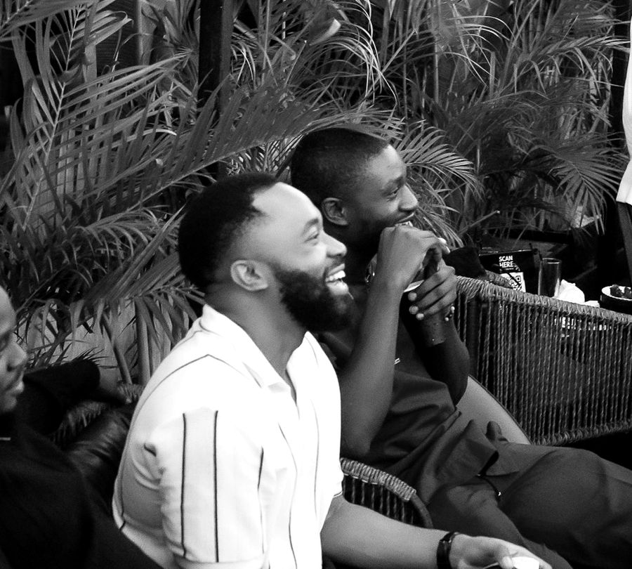 Members laughing together at a rooftop night