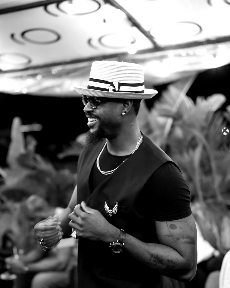 A member in a hat smiling on the rooftop